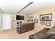 Finished basement featuring neutral carpeting, recessed lighting, and a large leather sofa, perfect for relaxing and watching movies at 11030 Brentwood Ave, Zionsville, IN 46077