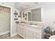 Bathroom featuring a dual sink vanity, decorative shelves and large mirror at 11030 Brentwood Ave, Zionsville, IN 46077