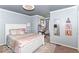Bedroom with a large bed, soft carpet, pastel color scheme, and a desk area at 11030 Brentwood Ave, Zionsville, IN 46077