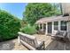 Outdoor deck with seating, offering a great view of the lush backyard at 11030 Brentwood Ave, Zionsville, IN 46077