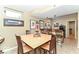 Inviting dining area with wood table, chairs, tile flooring, wet bar, and window bringing the outside in at 11030 Brentwood Ave, Zionsville, IN 46077