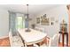 Comfortable dining room features a beautiful table setting, a large window, and hardwood flooring at 11030 Brentwood Ave, Zionsville, IN 46077
