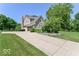 Lovely home featuring a well-kept lawn, mature trees, and an inviting driveway at 11030 Brentwood Ave, Zionsville, IN 46077