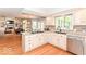Spacious kitchen with white cabinets, stainless steel appliances, and open layout to the living area at 11030 Brentwood Ave, Zionsville, IN 46077