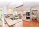 Modern kitchen with a breakfast bar, stainless steel appliances, granite countertops, and hardwood floors at 11030 Brentwood Ave, Zionsville, IN 46077