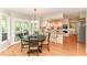 An open-concept kitchen and breakfast nook boasts a breakfast bar, light wood cabinets, and hardwood flooring at 11030 Brentwood Ave, Zionsville, IN 46077