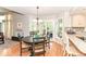 Breakfast nook features hardwood floors, a breakfast bar, and a delightful view of the sunroom at 11030 Brentwood Ave, Zionsville, IN 46077