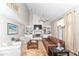 Cozy living room showcases a brick fireplace, built-in bookshelves, and soaring ceilings at 11030 Brentwood Ave, Zionsville, IN 46077