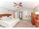 Main bedroom features carpeting, neutral colors, ceiling fan, en suite bath and an armoire at 11030 Brentwood Ave, Zionsville, IN 46077
