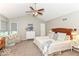 Primary bedroom featuring vaulted ceiling, neutral paint, carpeting, ceiling fan, and windows with blinds at 11030 Brentwood Ave, Zionsville, IN 46077