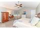 Spacious main bedroom featuring a ceiling fan, sitting area, walk in closet, neutral colors and carpeting at 11030 Brentwood Ave, Zionsville, IN 46077