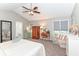 Main bedroom featuring vaulted ceiling, neutral paint, carpeting, ceiling fan, and sitting area at 11030 Brentwood Ave, Zionsville, IN 46077