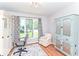 A bright office space is decorated with charming cabinets, warm hardwood floors, and lots of light at 11030 Brentwood Ave, Zionsville, IN 46077