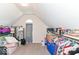Ample storage room with carpeted floor and sloped ceiling, ideal for organization at 11030 Brentwood Ave, Zionsville, IN 46077