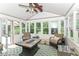 Bright sunroom filled with natural light, comfortable seating, and views of the outdoors at 11030 Brentwood Ave, Zionsville, IN 46077