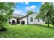 Inviting backyard featuring a patio, lush lawn, mature trees, and a grill for outdoor entertaining at 11518 Cherry Blossom W Dr, Fishers, IN 46038
