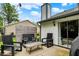 Charming backyard patio featuring modern seating, string lights, and a privacy screen for outdoor enjoyment at 11518 Cherry Blossom W Dr, Fishers, IN 46038