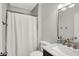 Bathroom featuring a shower with marble surround, white vanity, and gold fixtures at 11518 Cherry Blossom W Dr, Fishers, IN 46038
