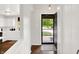 Bright entryway with hardwood floors and a view of the kitchen and front door at 11518 Cherry Blossom W Dr, Fishers, IN 46038