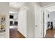 Hallway featuring a double door closet and access to rooms with hardwood flooring at 11518 Cherry Blossom W Dr, Fishers, IN 46038