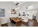 Well-lit dining area with view to the kitchen with stainless appliances and white cabinets at 11518 Cherry Blossom W Dr, Fishers, IN 46038