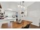 Bright kitchen and dining area boast white cabinetry, stainless appliances, and pendant lighting at 11518 Cherry Blossom W Dr, Fishers, IN 46038