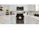 Bright kitchen with white quartz countertops, stainless steel appliances, and white subway tile backsplash at 11518 Cherry Blossom W Dr, Fishers, IN 46038