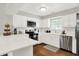 Modern kitchen features white cabinets, stainless steel appliances, and ample counter space at 11518 Cherry Blossom W Dr, Fishers, IN 46038