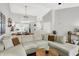 Open-concept living room features a large sectional sofa and hardwood flooring at 11518 Cherry Blossom W Dr, Fishers, IN 46038