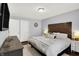 Spacious bedroom featuring a bed with neutral bedding and a wooden dresser at 11518 Cherry Blossom W Dr, Fishers, IN 46038