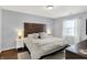 Comfortable main bedroom with wood headboard, bedside tables, and natural light at 11518 Cherry Blossom W Dr, Fishers, IN 46038