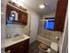Bathroom featuring tiled walls, updated vanity, and a shower with glass doors at 1206 Lincoln St, Shelbyville, IN 46176