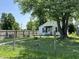 Inviting front yard showcasing a well-maintained lawn, a mature tree, and charming curb appeal at 1206 Lincoln St, Shelbyville, IN 46176