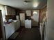 Functional laundry room equipped with a washer, dryer, and storage cabinets at 1206 Lincoln St, Shelbyville, IN 46176