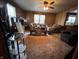 Cozy living room featuring wood paneling, carpet, and a ceiling fan at 1206 Lincoln St, Shelbyville, IN 46176