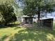 A home and a yard with green grass and trees in the background at 1206 Lincoln St, Shelbyville, IN 46176