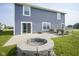 Private backyard featuring a patio area with a fire pit and grass at 1278 W Limestone Way, Fortville, IN 46040