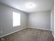 Bedroom featuring neutral carpet, walls, white trim, and a window providing natural light at 1278 W Limestone Way, Fortville, IN 46040