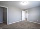 Neutral bedroom featuring carpet, walls, white trim, and doors providing access to other rooms at 1278 W Limestone Way, Fortville, IN 46040