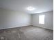 Spacious bedroom with neutral tones, carpeted floors, and a bright window at 1278 W Limestone Way, Fortville, IN 46040