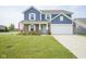 Charming two-story home featuring a well-manicured lawn and a two-car garage at 1278 W Limestone Way, Fortville, IN 46040