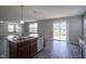 Spacious kitchen with an island, stainless steel appliances, and wood flooring at 1278 W Limestone Way, Fortville, IN 46040