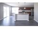 Modern kitchen featuring an island, stainless steel appliances, and sliding glass doors at 1278 W Limestone Way, Fortville, IN 46040