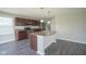 Bright kitchen with an island, stainless steel appliances, and wood flooring at 1278 W Limestone Way, Fortville, IN 46040