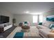 Bright living room featuring modern furniture, accent pillows and decorative rug on dark surface flooring at 1278 W Limestone Way, Fortville, IN 46040