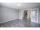 Open room with French doors and view to stairs and powder room, hard surface flooring and neutral walls at 1278 W Limestone Way, Fortville, IN 46040