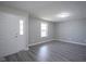 Unfurnished room with white door, window and hard surface floors with neutral walls and ceiling light at 1278 W Limestone Way, Fortville, IN 46040