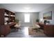 Home office with dual desk areas, built-in shelving, and comfortable seating with neutral walls and lighting at 1278 W Limestone Way, Fortville, IN 46040
