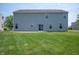 Large backyard with a big grass lawn, patio, and a neutral colored two-story home at 1312 Donald Pass, Greenwood, IN 46143