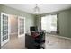 Bedroom/office with french doors, natural light, and neutral tones creating a serene workspace at 1312 Donald Pass, Greenwood, IN 46143